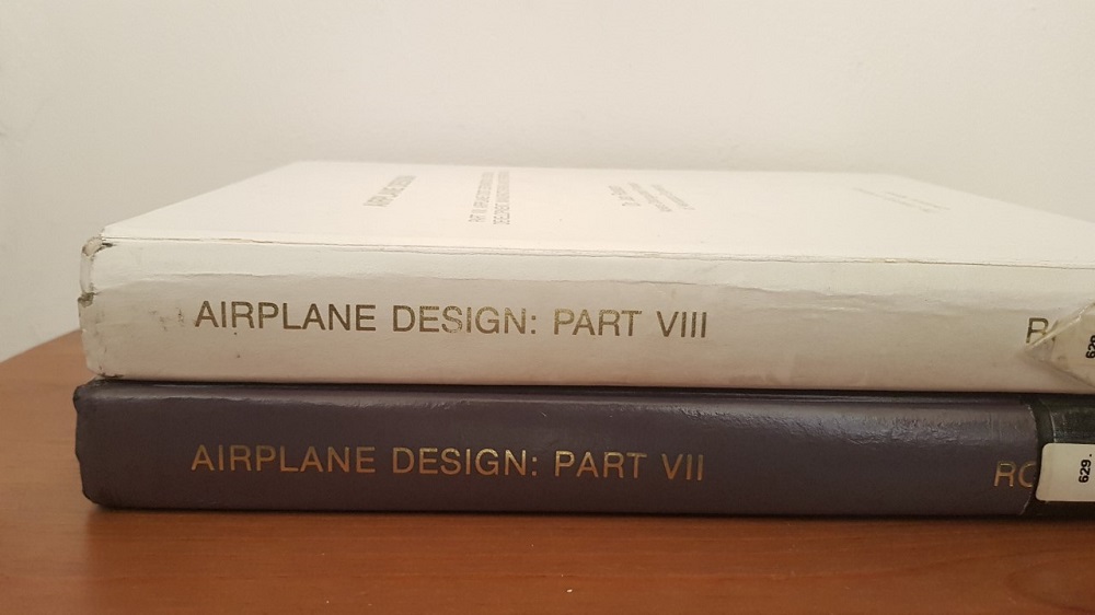 A brown Airplane Design book part VII and a white Airplane Design book part VIII stacked on top of each other. 