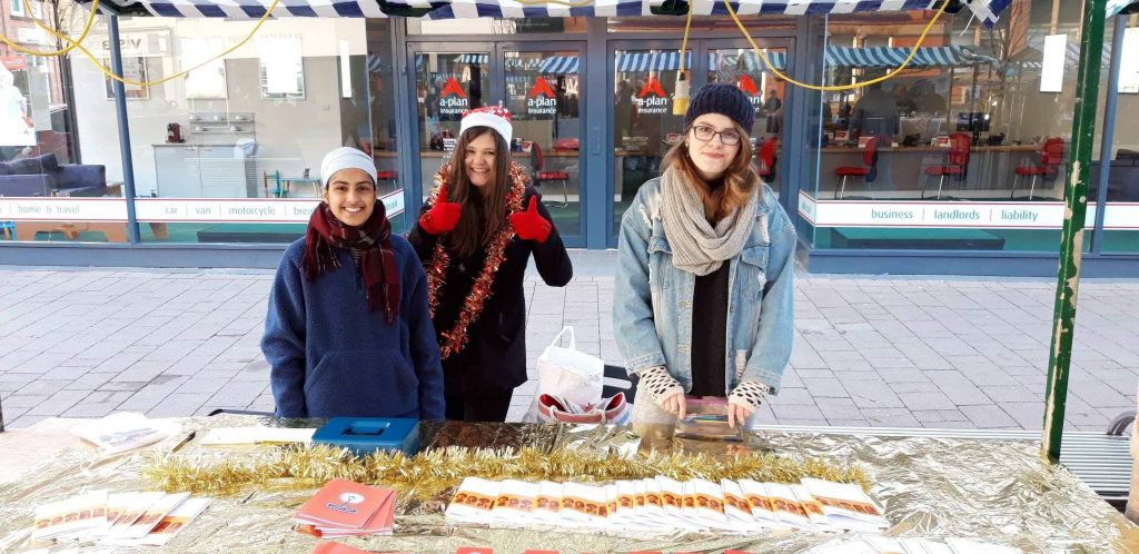 Gugundeep and two friends at a market stall. 