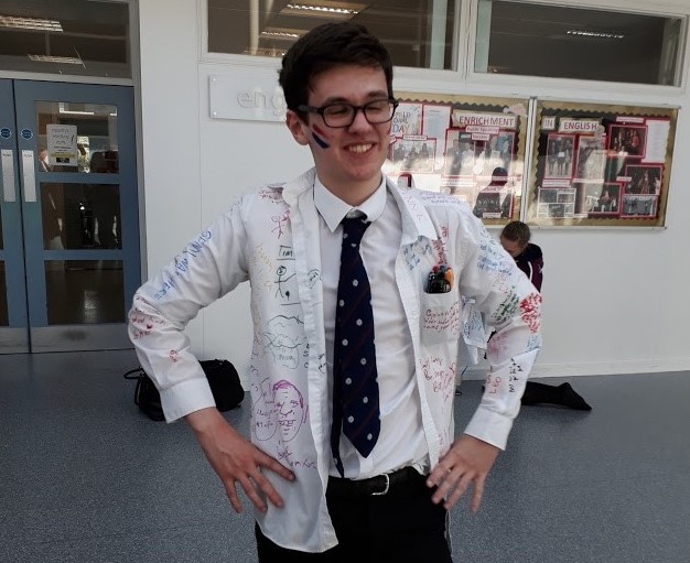 David at school in his school shirt which has writing all over it. 