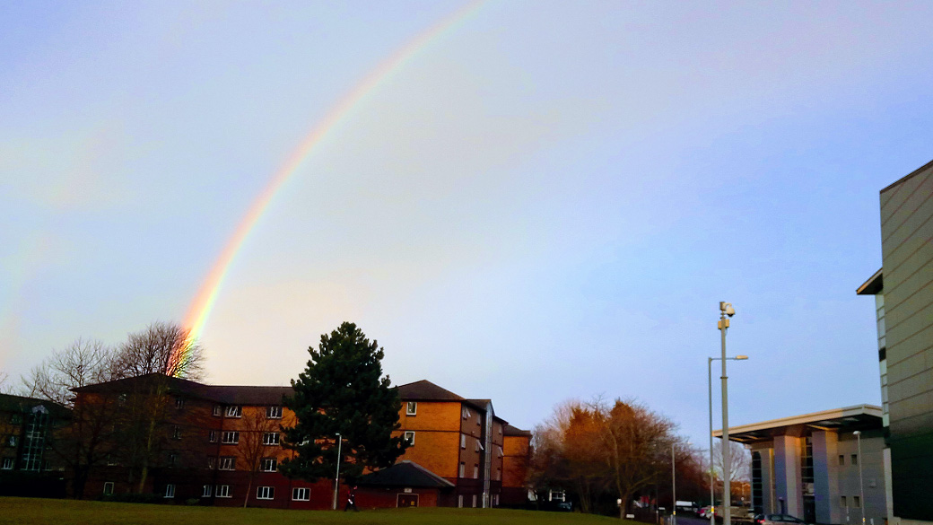 A rainbow over Butler Court with a blue sky behind it. 
