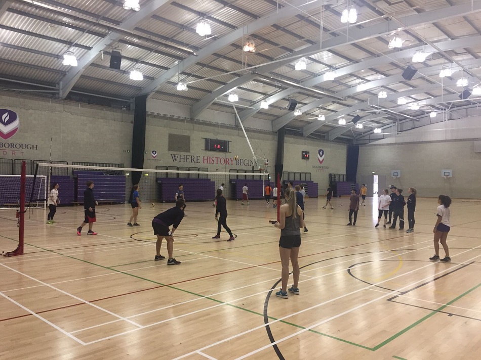 Students playing volleyball in Sir David Wallace sports hall at Loughborough University.  