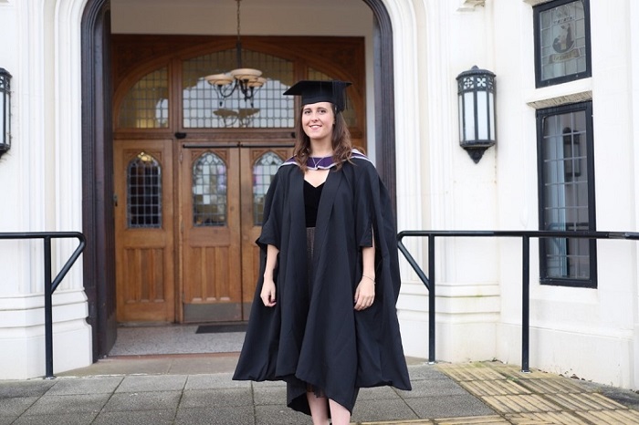 Photograph of Hannah on her graduation outside the Hazelrigg building at Loughborough University. 