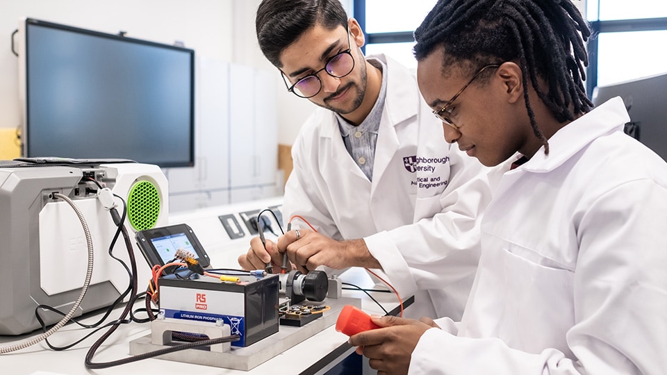 Two people working with equipment in the General Engineering Laboratory within STEMLab at Loughborough University