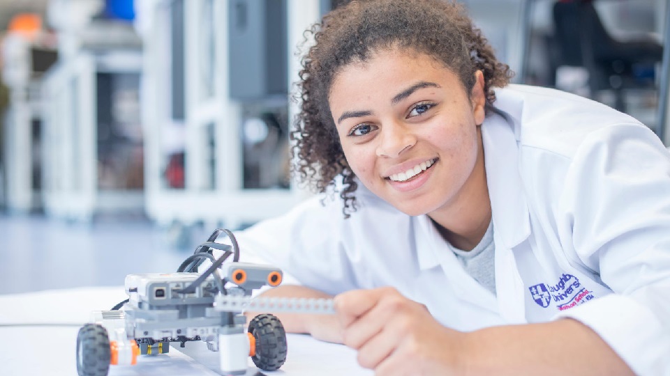 a student holding a model