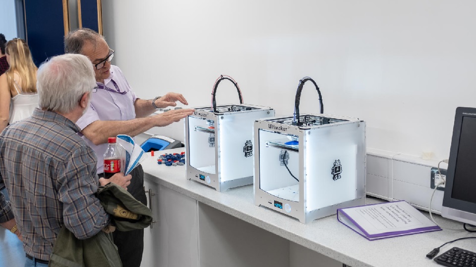 two men discussing some lab equipment