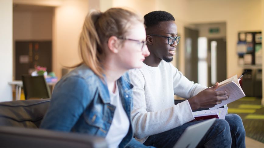 David Abiona studying with other students