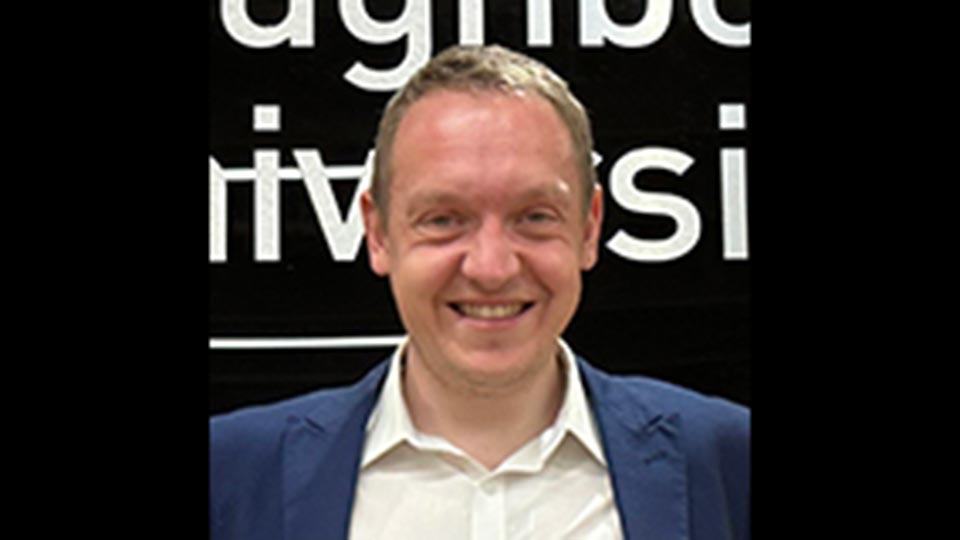 A student smiling to camera