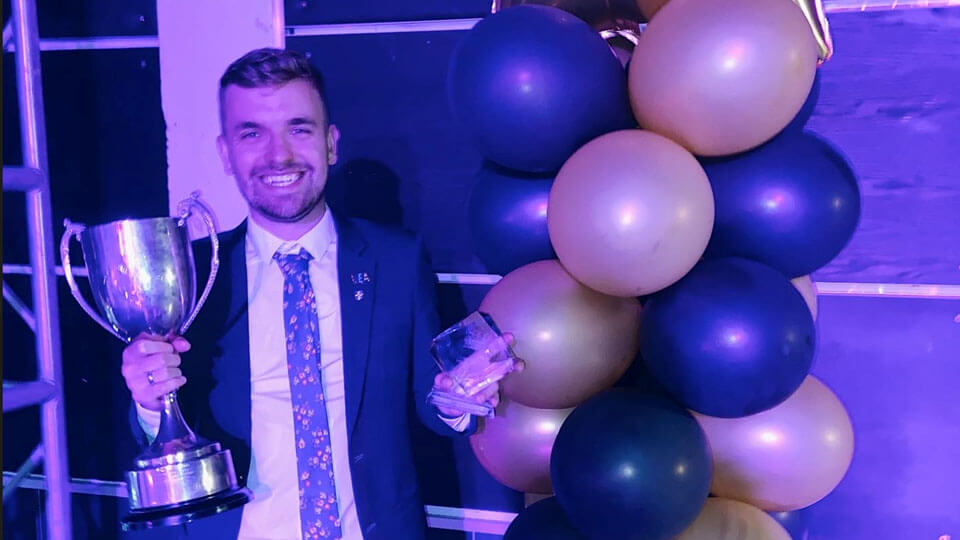 Student smiling with awards