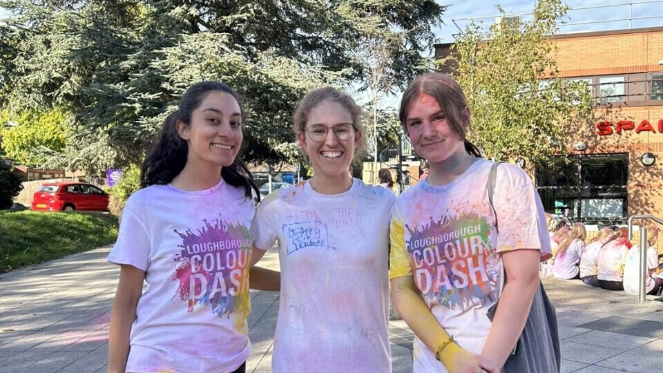 Group of three students smiling 