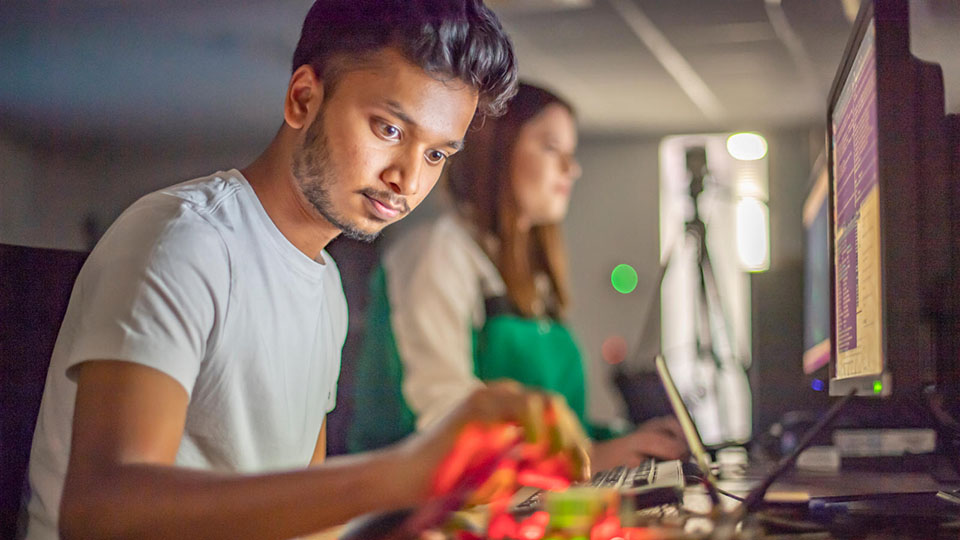 A student working with equipment in a Computer Science laboratory