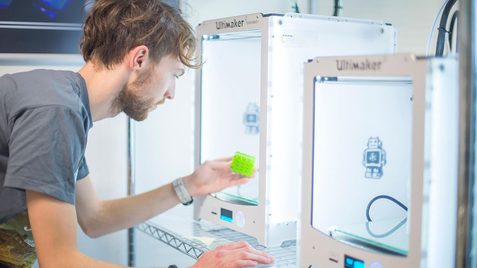 A student using a piece of equipment in the Loughborough University Design School