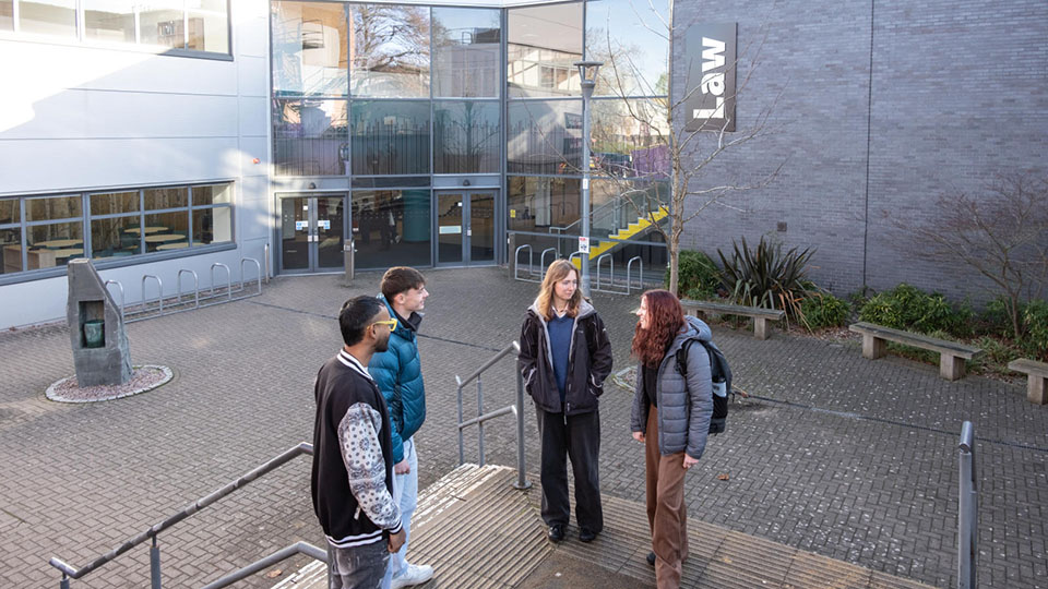 A group of students standing outside the Stewart Mason building at Loughborough University