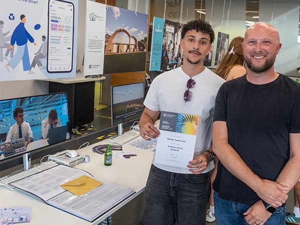 Nathan and his Programme Leader stand next to his final-year project, which received the Innovation Award at Loughborough University.