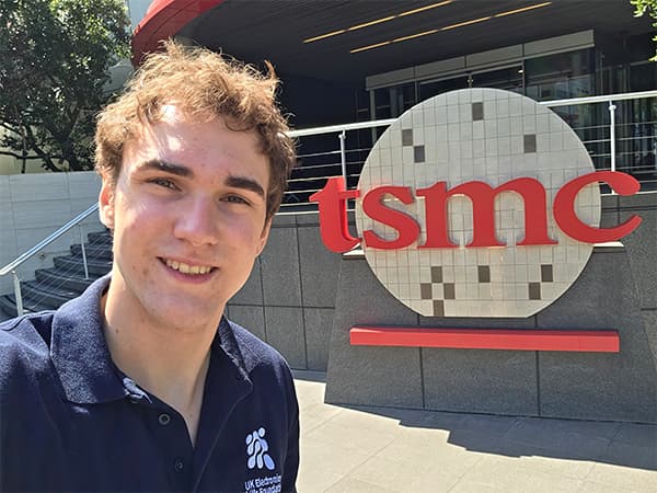 Zachary stood next to the TSMC sign.