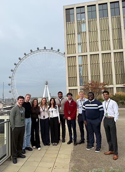 Zoe stood outside by the London Eye with her colleagues at IBM.