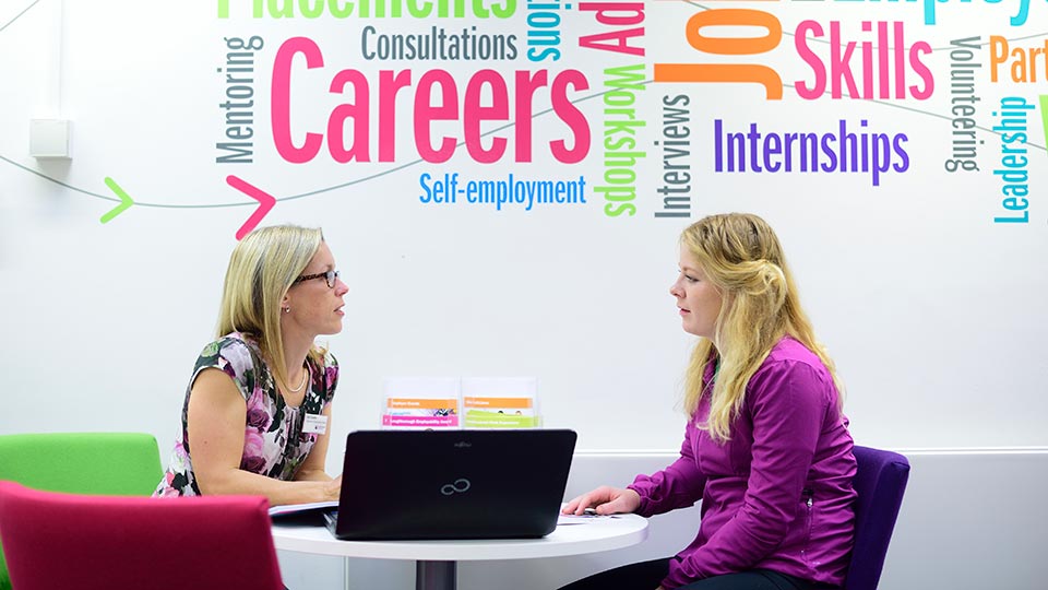 A student sat talking to a careers advisor