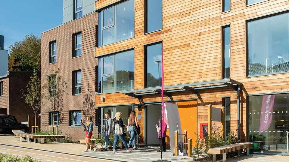 Open day visitors viewing halls of residence on campus.