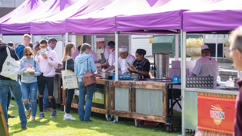 Open day visitors eating at the EHB BBQ