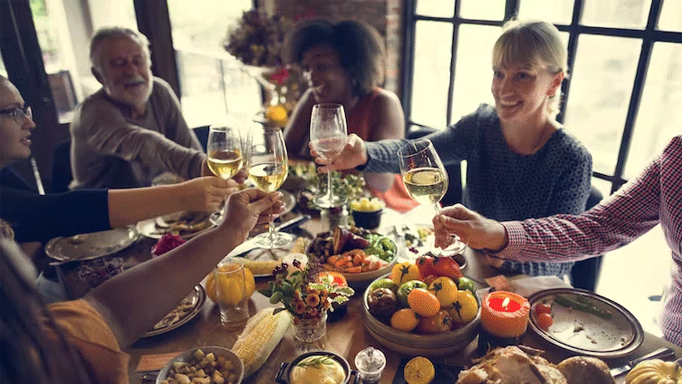 a group of people eating christmas dinner