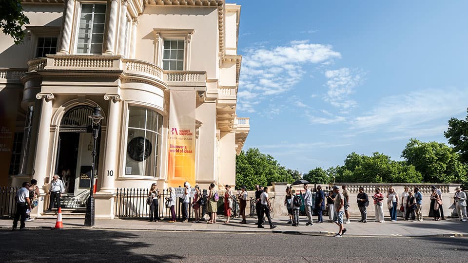 a queue of people for the exhibition