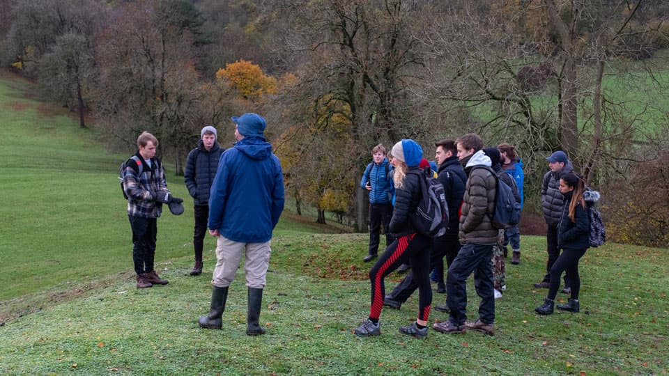 a group of people standing on a hill in the Peak District