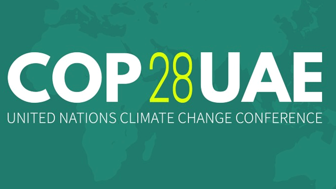 A green logo image with white words saying 'COP 28 UAE'