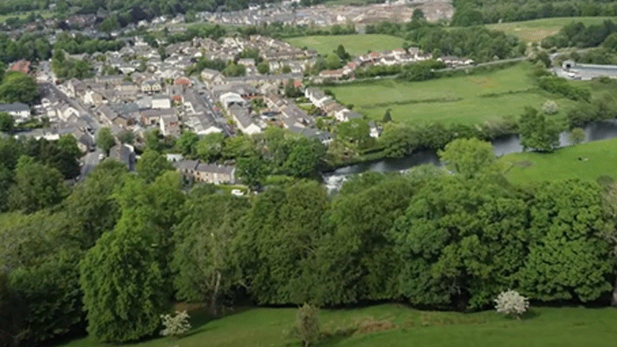 drone shot of a town and fields