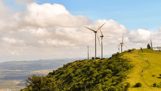 wind turbines on top of a hill