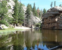 a lake surrounded by trees and rocks