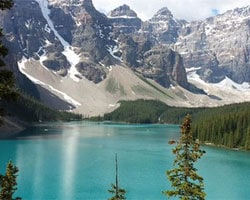 a lake with the alps in the backround