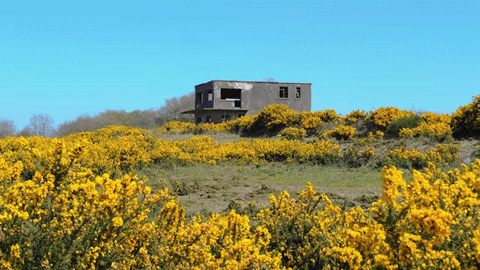 an abandoned control tower in a field