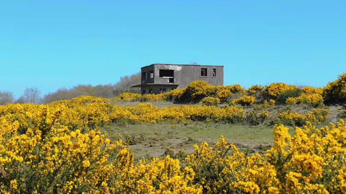 an abandoned control tower in a field