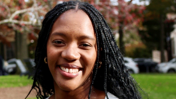 A close up of a female student outside smiling the camera