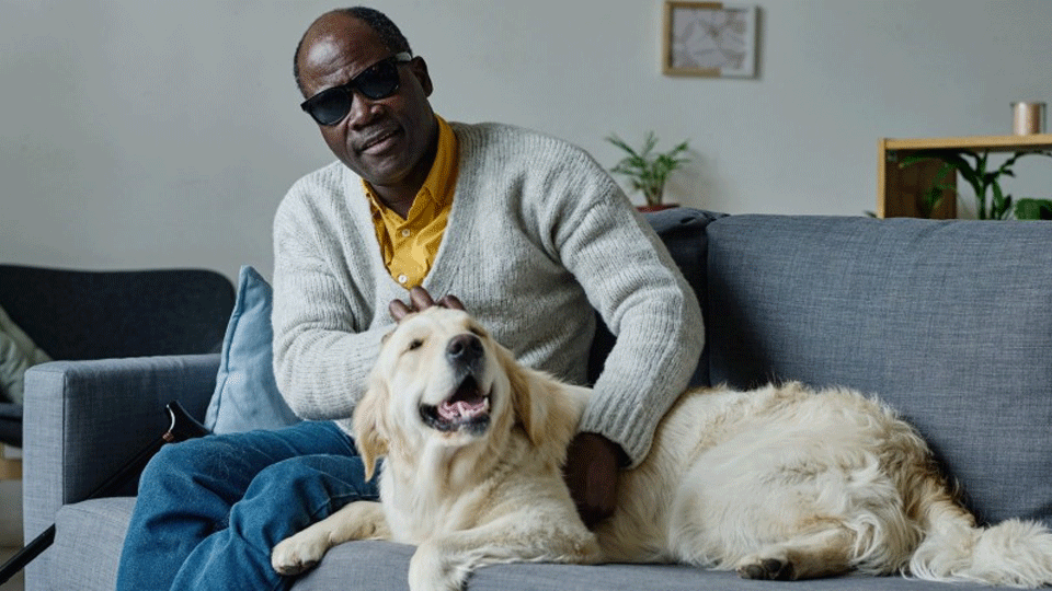 A blind man with his assistance dog