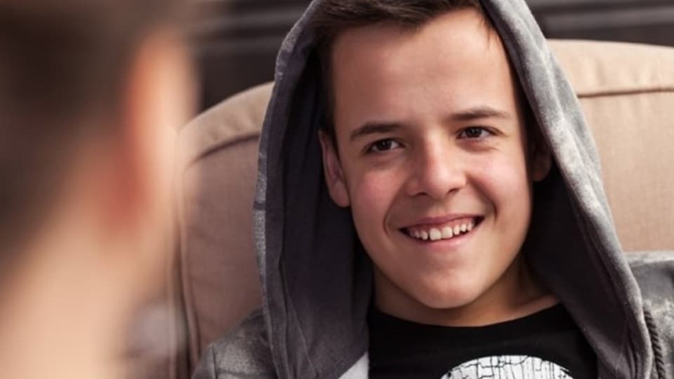 a young man in a hoody