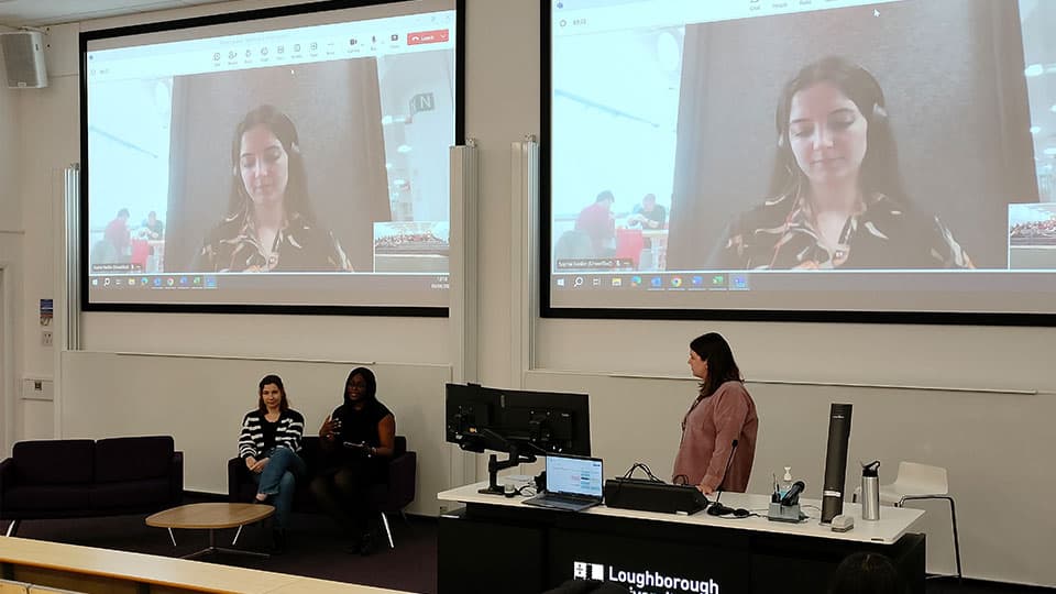 Inspiring Minds session on 4 April in a lecture hall at Loughborough University.  There are two panellists, one on screen on a Teams call and the other sitting on a chair in front.