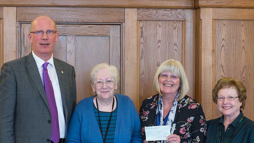 Vice Chancellor presenting cheque to community group