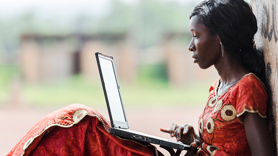 Photo of a woman sitting with laptop