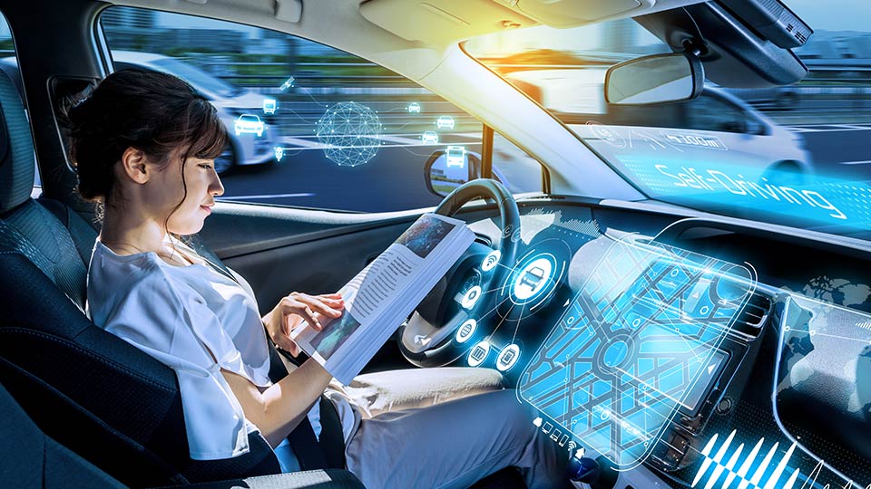 Woman reading in a self-driving car.