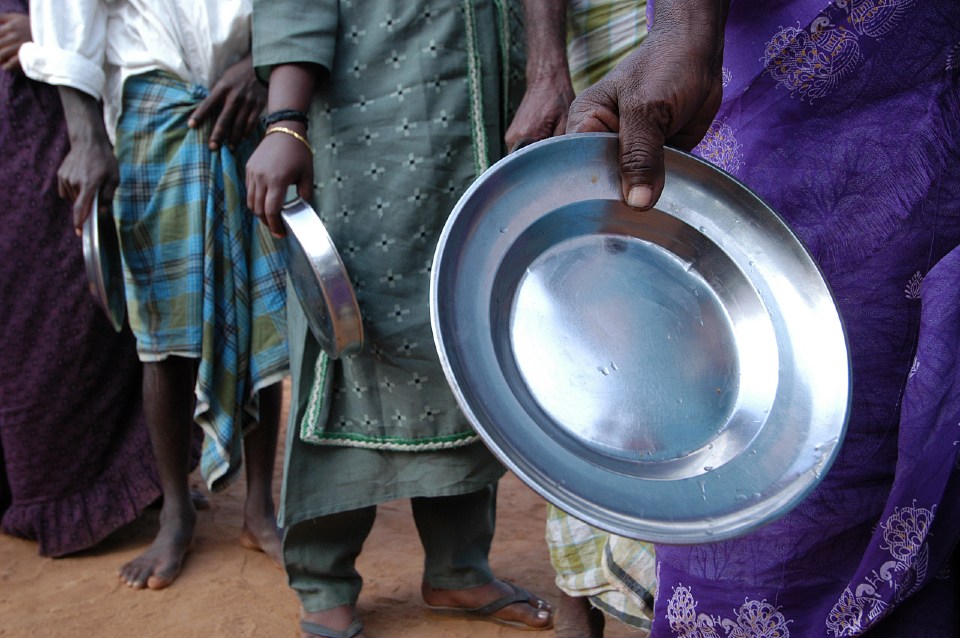 Displaced community waits in line for food. 