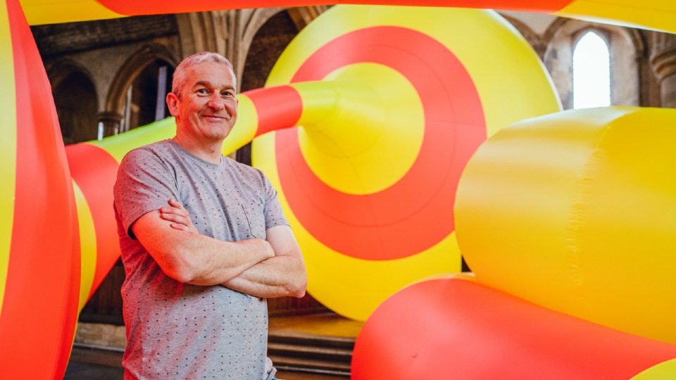 Michael Shaw stood in front of a inflatable sculpture 