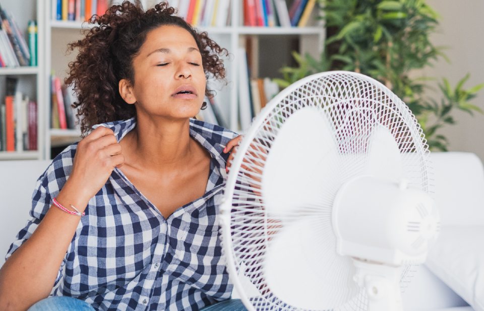 Woman sat in front of a fan