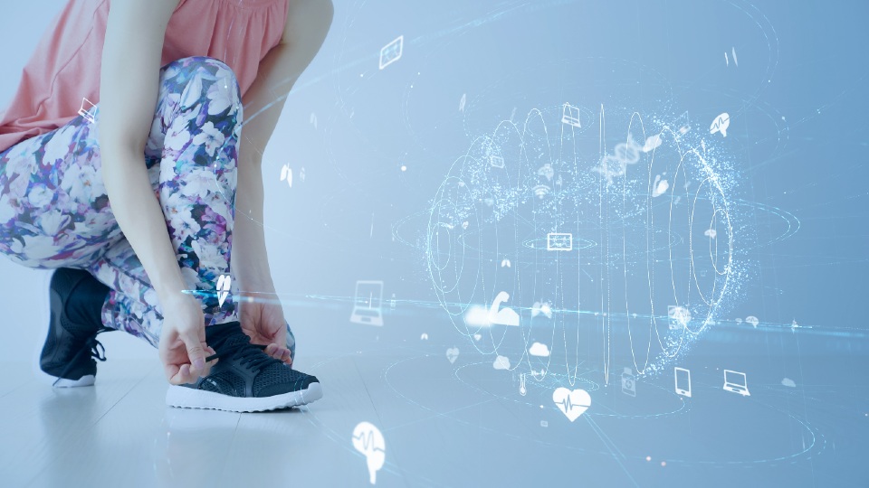 Woman tying trainers with tech symbols around her 