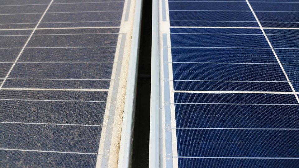 Soiled solar panel next to a clean one 