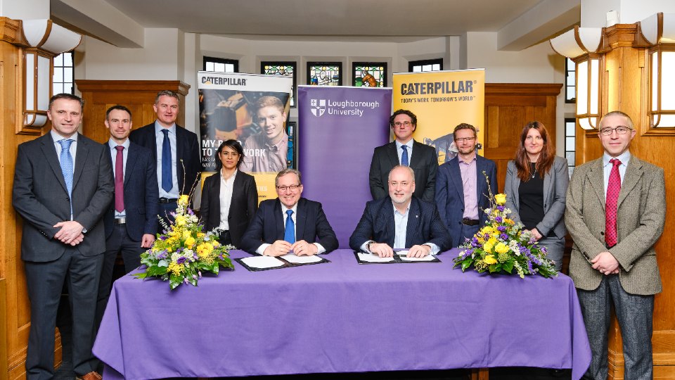 Centre left to right: David Goldspink, Caterpillar Vice President and General Manager and Professor Nick Jennings, Loughborough University Vice-Chancellor with members of Caterpillar and the Innovation and Research Centre