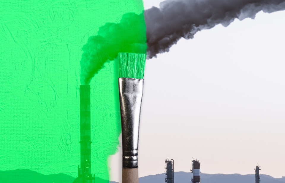 Image of a paint brush that has coloured half of a factory green while the other half emits smoke 
