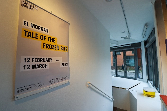 The poster at the start of El's exhibition, in the background is a pot will yellow steaming liquid in it