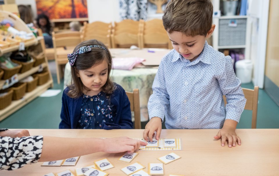 Two children playing feed the monsters