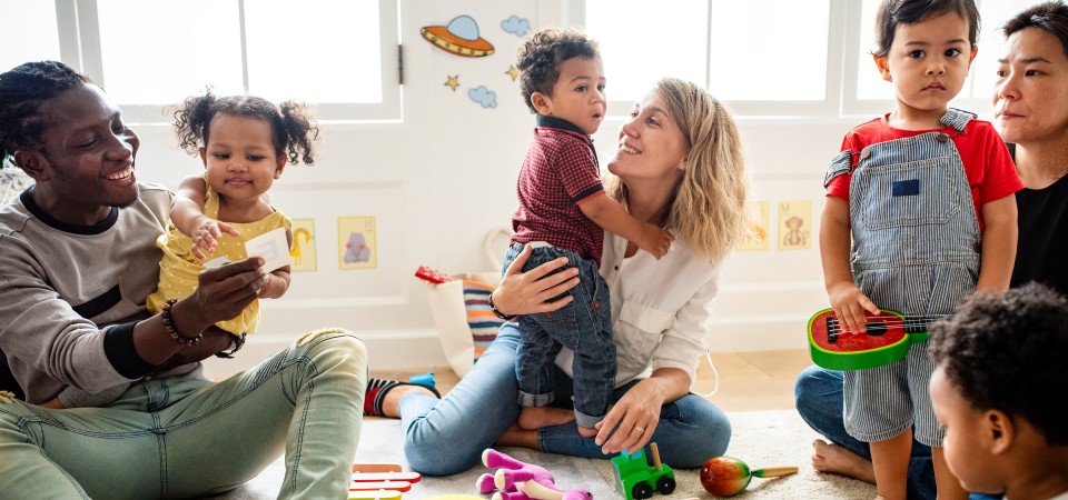 A nursey with children and parents playing