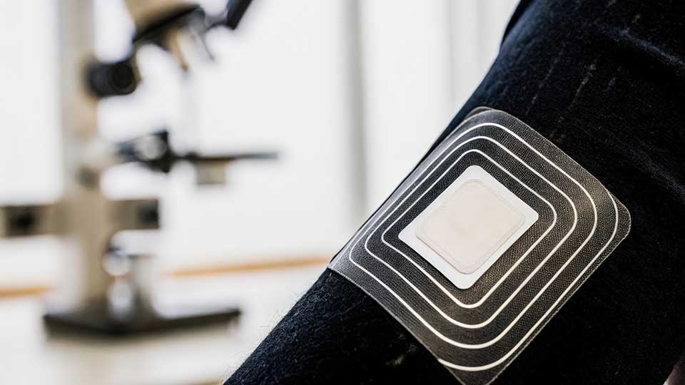 A wireless wearable on someone's arm.